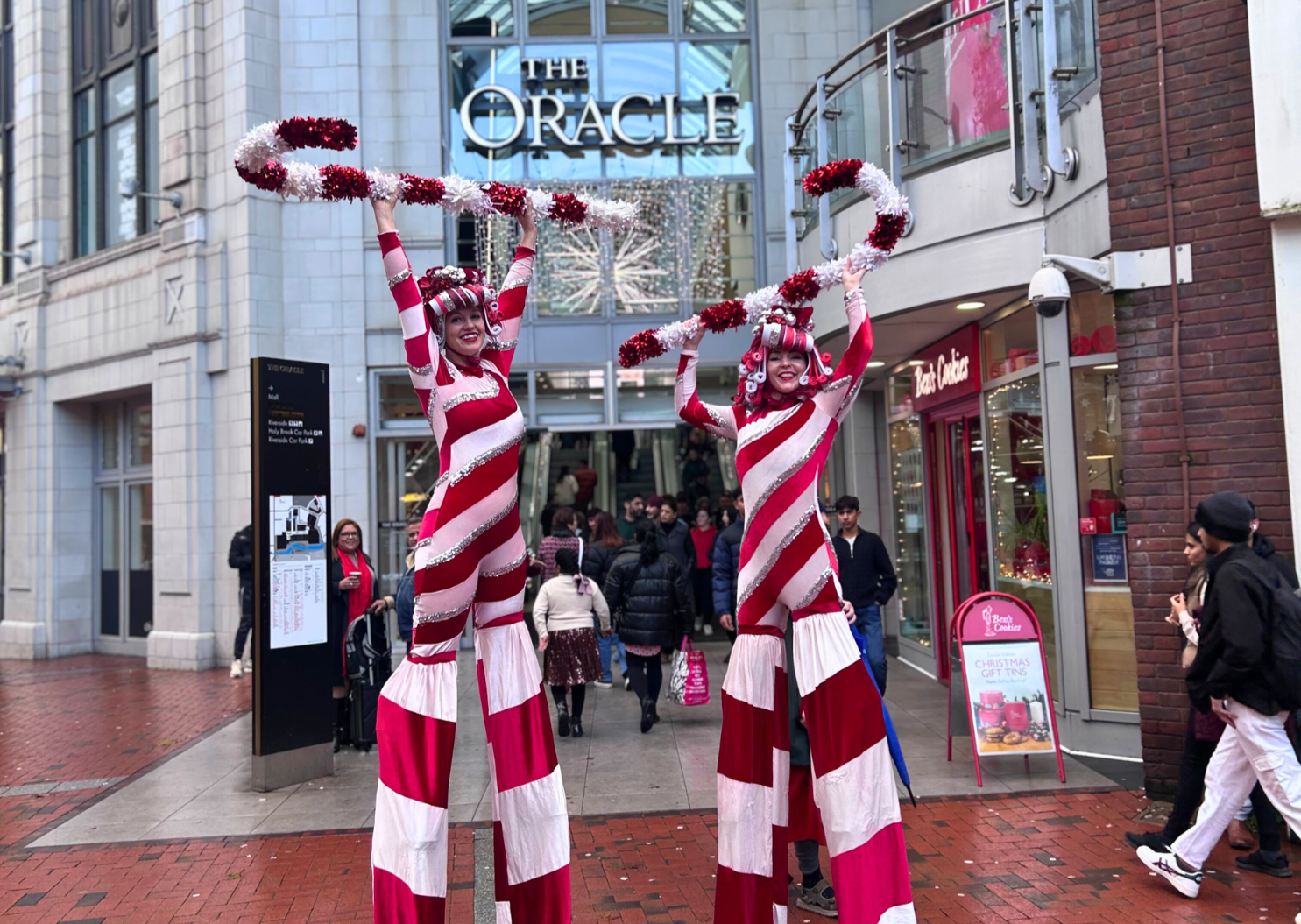 Candy Cane stilt walkers outside The Oracle